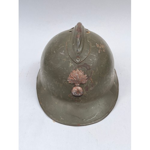 9268 - A French Infantry Adrian helmet, green painted, with RF badge to front, liner intact