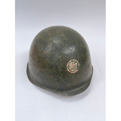 9270 - A Soviet Hungarian M50 helmet, signs of red star emblem within a roundel, liner intact