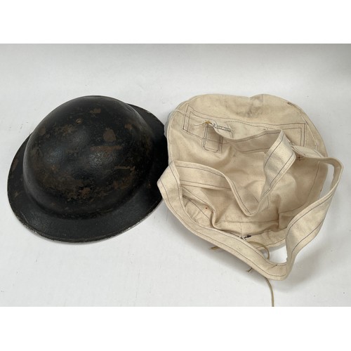 9276 - A WWII Brodie helmet with associated cover