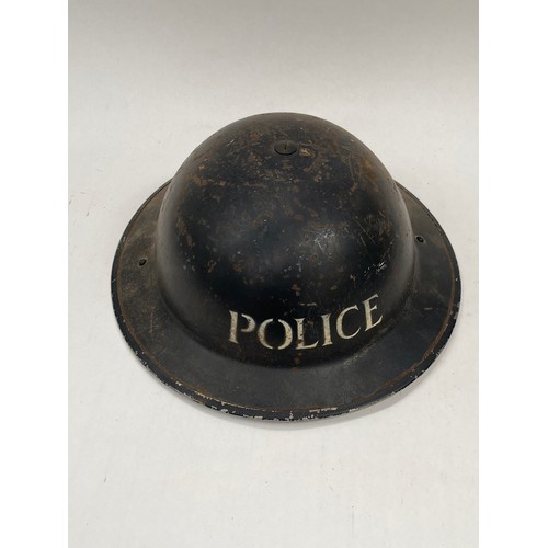 9275 - A WWII Brodie helmet with police lettering, 1939 dated to liner (a/f)