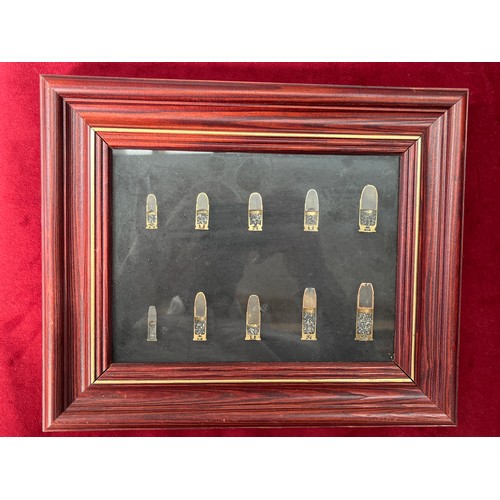 9501 - A framed display of inert small arms ammunition cross-sections including .25ACP, 9mm and .45