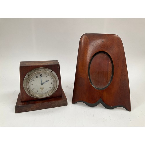 9310 - An early 20th Century car clock in wooden stand together with a wooden propeller tip photo frame (2)... 