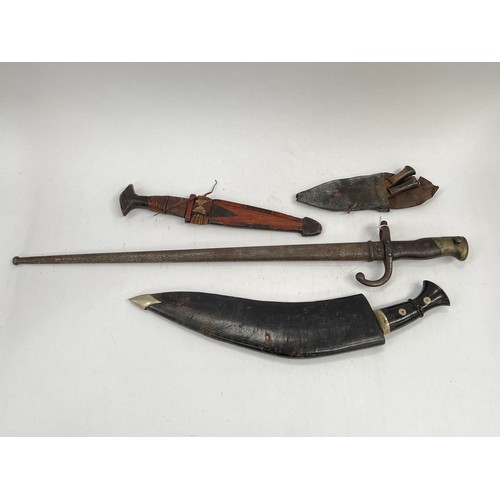 9505 - A 19th Century French Gras bayonet with scabbard, an African leather bound knife and a decorative ku... 