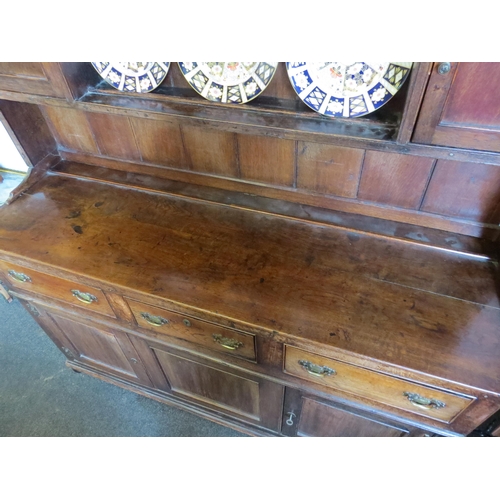 1009 - An early 19th Century stained oak dresser with three drawers and cupboards to the base and a board-b... 