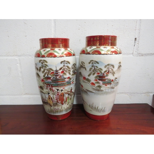 1036 - A pair of 20th Century Japanese porcelain vases with pagoda and figural design, satsuma tones, 37cm ... 