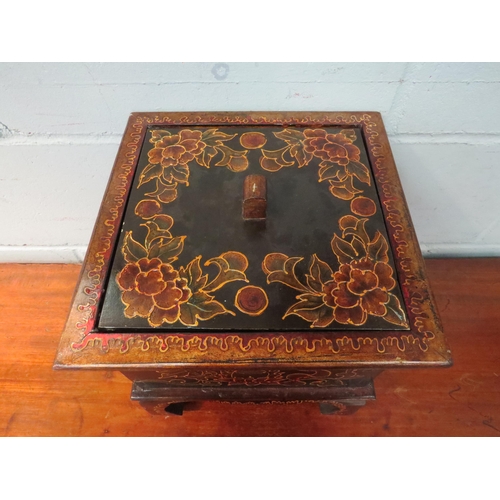 1046 - A Chinese lacquered lidded storage box with floral design on raised feet, 28cm high