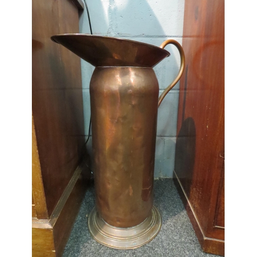 1049 - A copper oversized jug stick stand, 65cm high