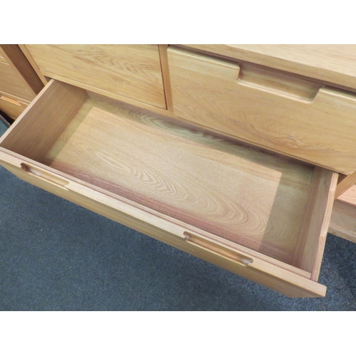 1069 - A modern light oak chest of two over three drawers with recessed handles, 95cm high x 91cm wide x 43... 