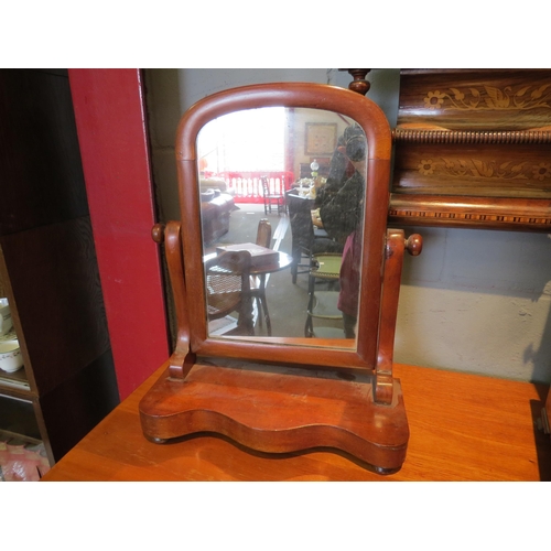 1099 - A Victorian mahogany swing toilet mirror on shaped plateau base