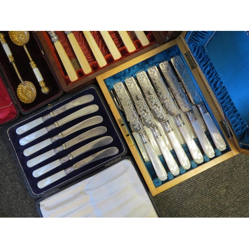 1305 - A cased set of mother-of-pearl cutlery together with three others (4)