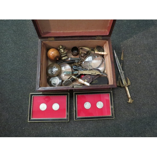 1486 - A box containing a collection of trinkets including map glass and horn loupe, magnifying glass etc