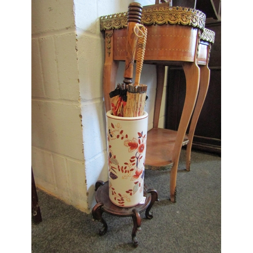 1015 - An Oriental umbrella stand with parasol contents and an Oriental vase stand