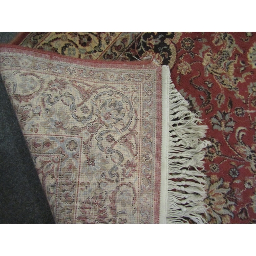 1192 - A 20th Century floral design rug with tasselled ends, 198cm x 140cm