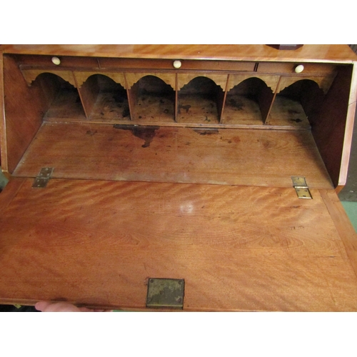 4029 - An early 19th Century satin walnut bureau the fitted interior over three graduating long drawers on ... 