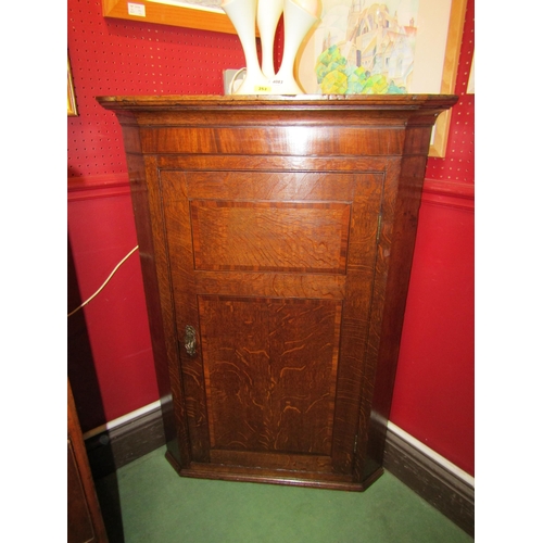 4047 - A George III oak wall-hanging corner cupboard with ebony line and mahogany cross banding, the single... 