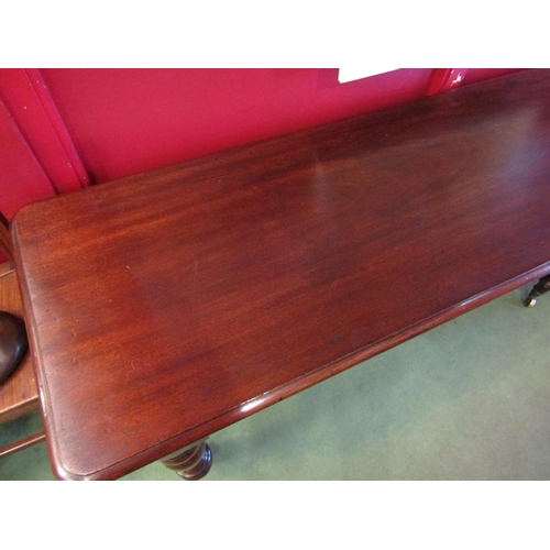 4055 - An Early Victorian flame mahogany serving table the round cornered top over baluster turned legs on ... 