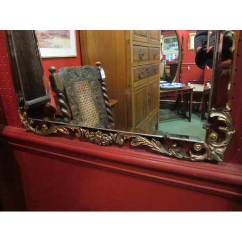 4064 - A circa 1930 pier mirror with carved gilt decoration, 113cm x 45cm