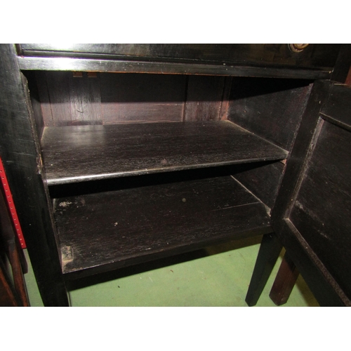 4095 - Circa 1900 an ebonised music cabinet the raised back over four drawers with drop-down fronts over a ... 