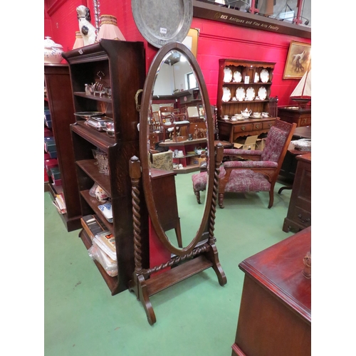 4127 - An Edwardian oak oval cheval mirror on barley twist supports, 162cm high x 64cm wide