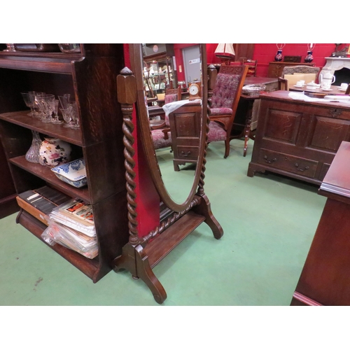 4127 - An Edwardian oak oval cheval mirror on barley twist supports, 162cm high x 64cm wide