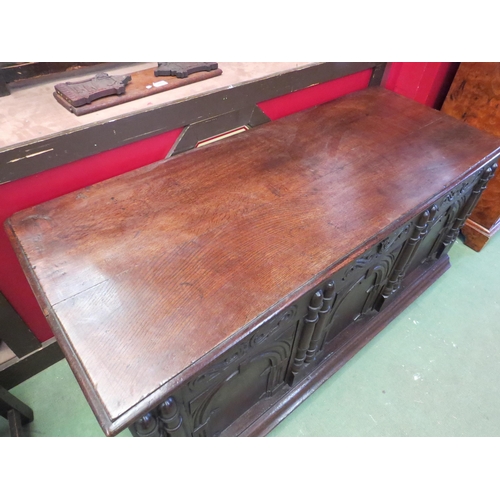 4168 - A Circa 1800 pegged oak three panel coffer with carved and moulded decorative front, the hinged lid ... 