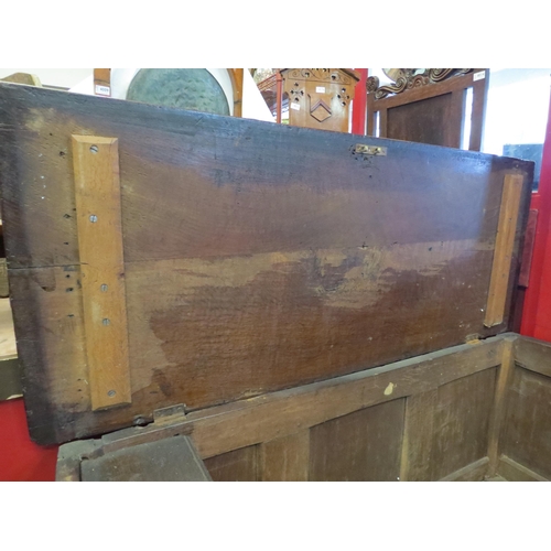 4168 - A Circa 1800 pegged oak three panel coffer with carved and moulded decorative front, the hinged lid ... 