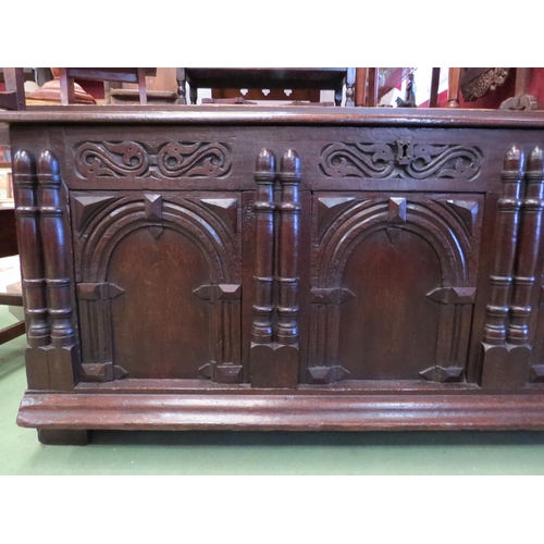 4168 - A Circa 1800 pegged oak three panel coffer with carved and moulded decorative front, the hinged lid ... 