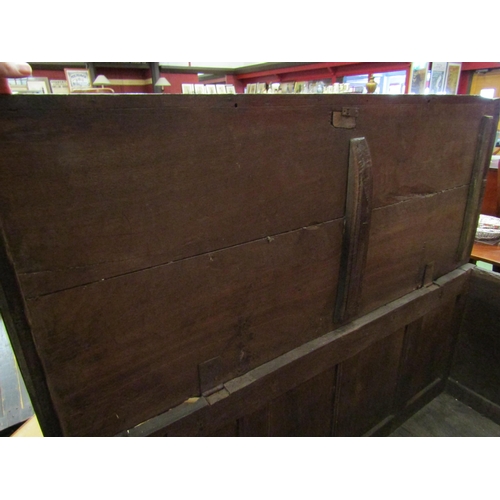 4171 - An 18th Century pegged oak large coffer the rising two plank lid over a four panelled front with car... 