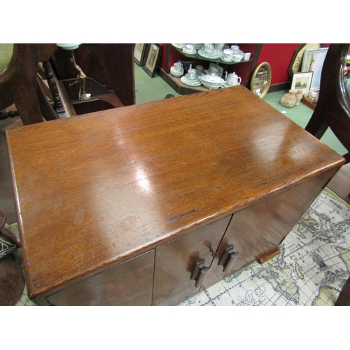 4214 - An Art Deco oak table top stationery cupboard the two doors opening to reveal a four section interio... 