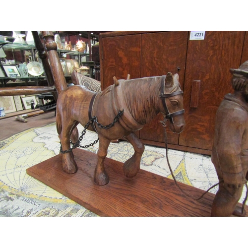 4275 - An Anton Wagner carved figure of shire horse and handler, monogrammed A.W. to base, (base 57cm long)