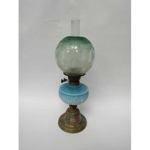 5063 - A decorative brass and blue glass oil lamp, globe repaired   (E) £10-15