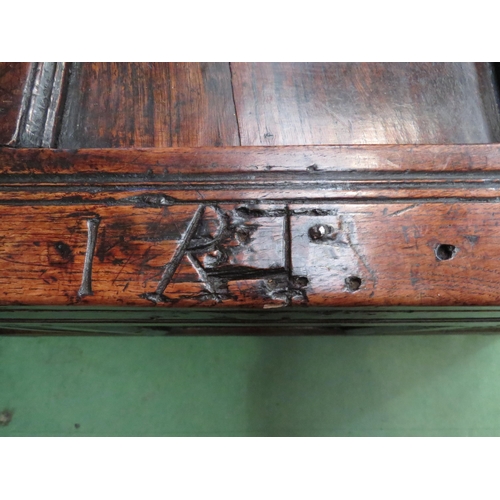 4004 - An 18th Century pegged oak three panel coffer, the ring pin hinged lid over stile feet with whorl sp... 