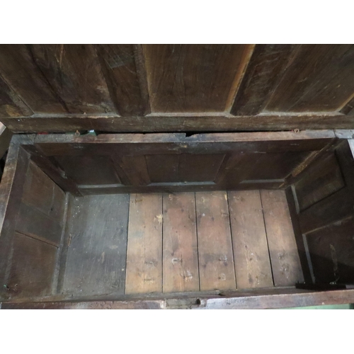 4004 - An 18th Century pegged oak three panel coffer, the ring pin hinged lid over stile feet with whorl sp... 