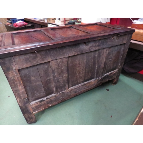 4004 - An 18th Century pegged oak three panel coffer, the ring pin hinged lid over stile feet with whorl sp... 