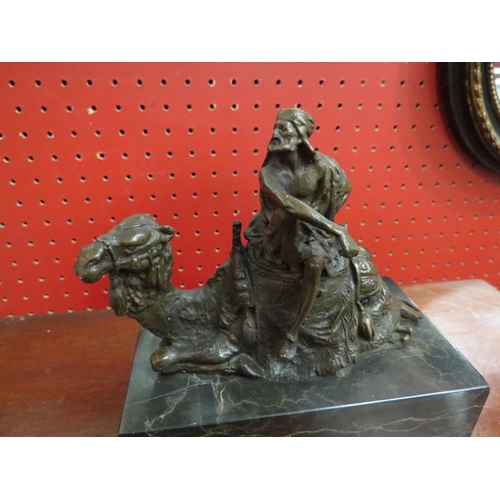 4053 - A bronze seated camel with rider on marble base, 15cm tall