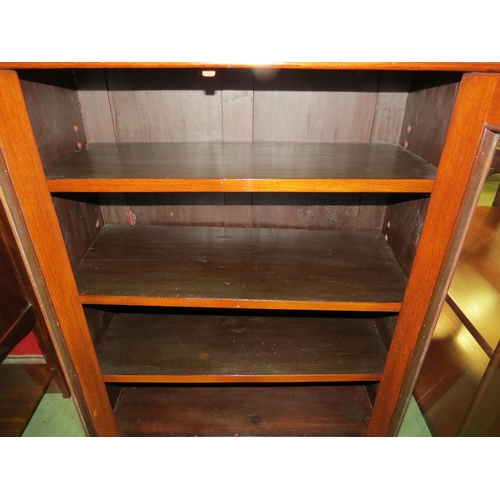 4069 - An Edwardian mahogany two door glazed bookcase with key over a plinth base, 103cm high x 76cm wide x... 