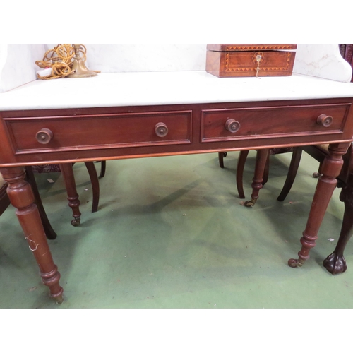 4114 - A 19th Century mahogany marble topped wash stand with two drawers on turned legs to castors, 88cm hi... 