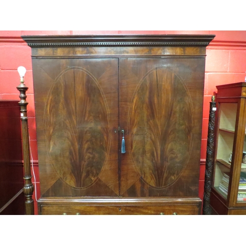 4134 - A George III crossbanded flame mahogany linen press, the two doors with key opening to reveal four s... 