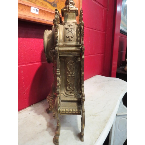 4153 - A brass heavily ornate mantel clock, ceramic numeral plates on dolphin outswept supports, 58cm high