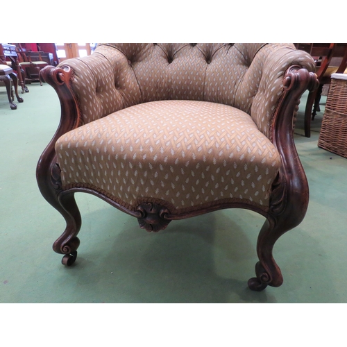 4164 - A Victorian walnut button-back armchair with scroll carved arms and fore legs on castors