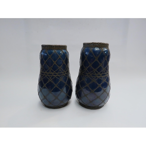 4391 - A pair of Japanese vases in cobalt blue encased with a wirework design, 20cm high, one a/f,