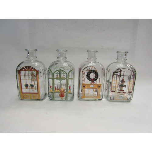 4441 - Four Holmegaard glass Christmas design bottles and a glass oil lamp