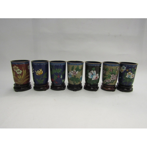 4443 - A set of 12 Japanese cloisonne pots within a display shelf, various designs incuding floral sprays