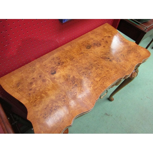 4104 - A George II revival burr walnut card table, the hinged fold-over top on a single frieze drawer base ... 