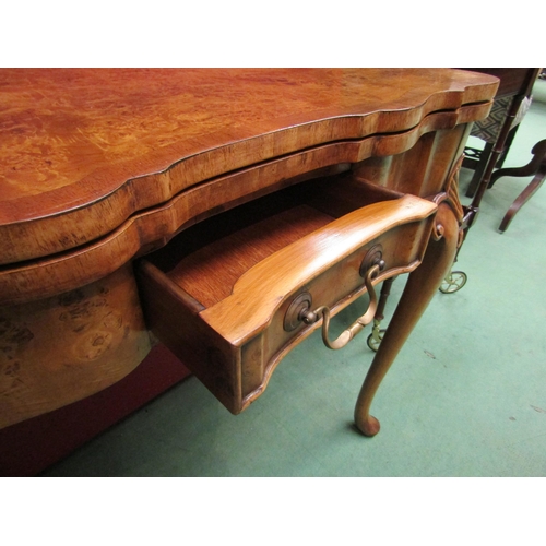 4104 - A George II revival burr walnut card table, the hinged fold-over top on a single frieze drawer base ... 