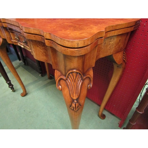 4104 - A George II revival burr walnut card table, the hinged fold-over top on a single frieze drawer base ... 