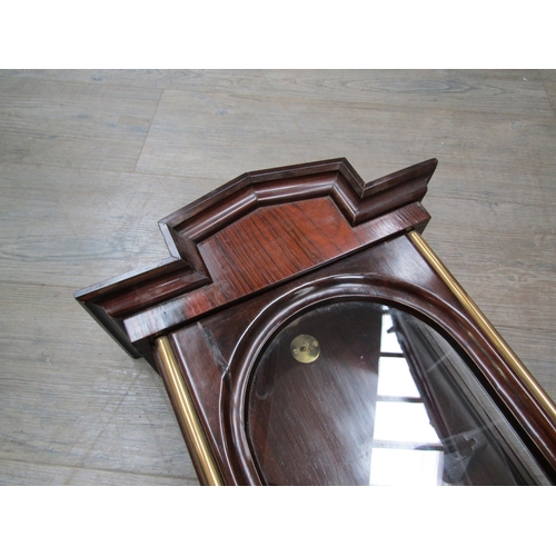 6033 - A rosewood Vienna wall clock case and pendulum (no face or movement), 122cm tall