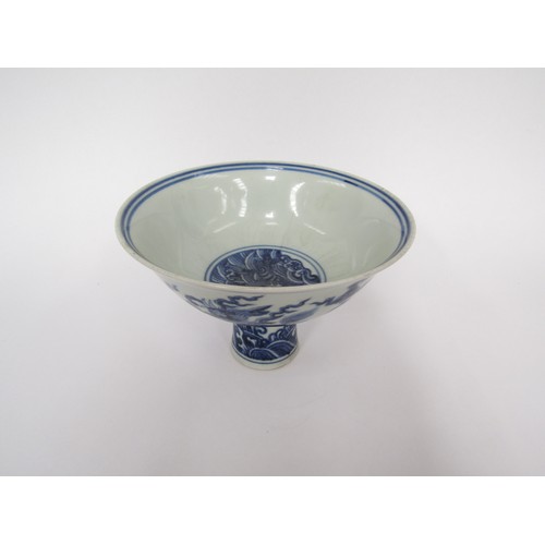 9032 - A Chinese blue and white stem cup with winged dragon and waves, six character marks within base, hai... 
