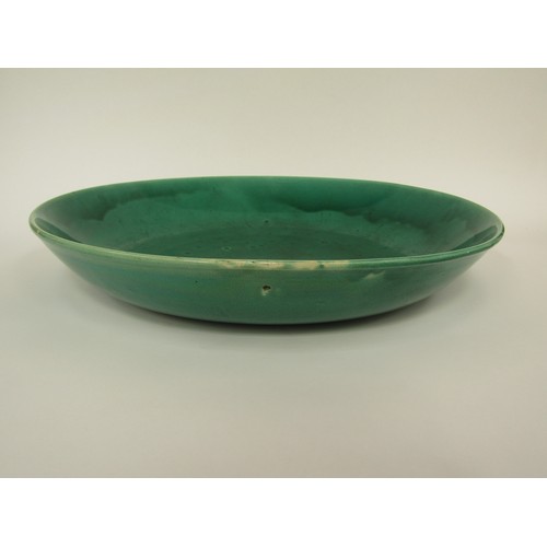 9037 - WITHDRAWN: A Chinese green glazed charger, 42.5cm diameter