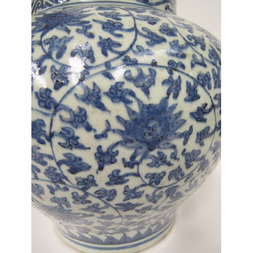 9031 - A Chinese blue and white bulbous form jardinière with scrolling lotus flower decoration, unmarked, 3... 